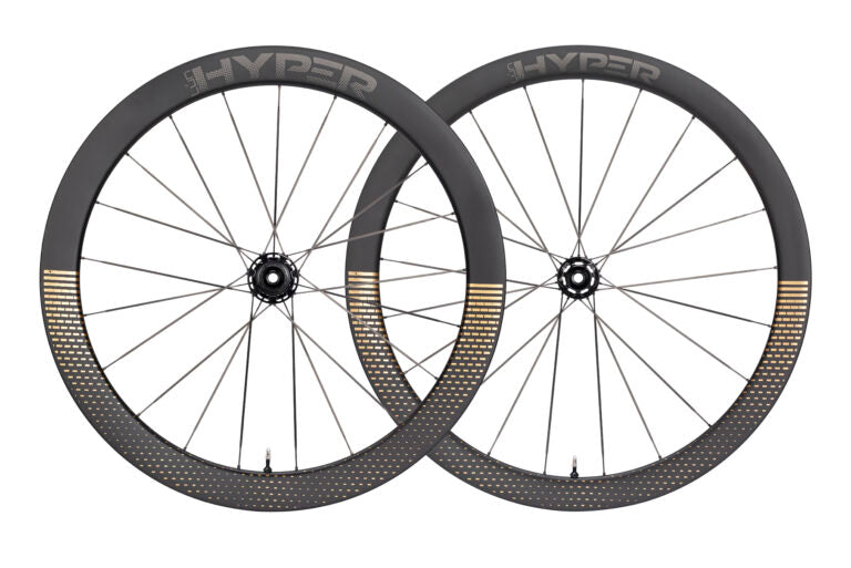 Lún HYPER D45 disc brake carbon wheelset, matte black rims with gold fading pattern and HYPER logo on white background.