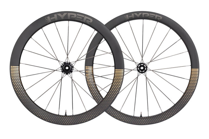 Lún HYPER D45 disc brake carbon wheelset, matte black rims with gold fading pattern and HYPER logo on white background.