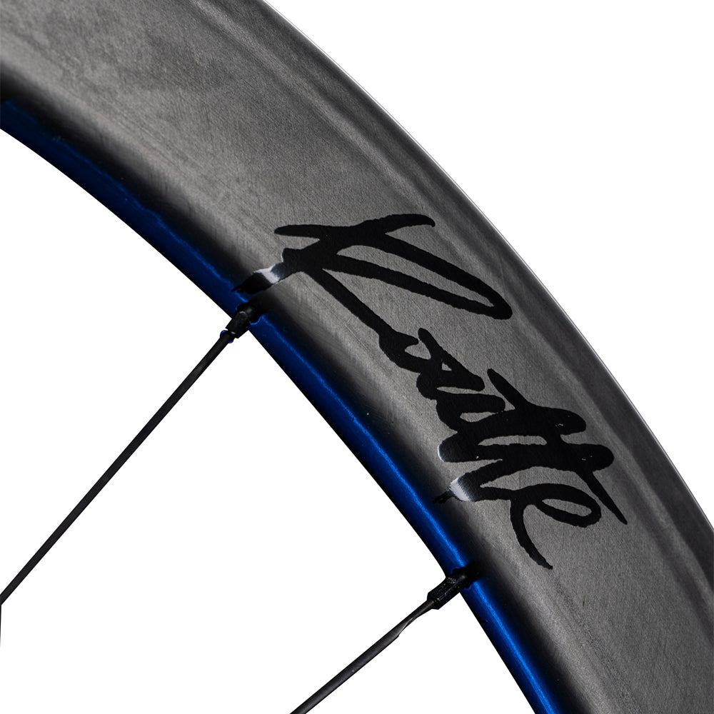 Lún Routte matte carbon wheelset close-up with black Routte branding and blue accent line.