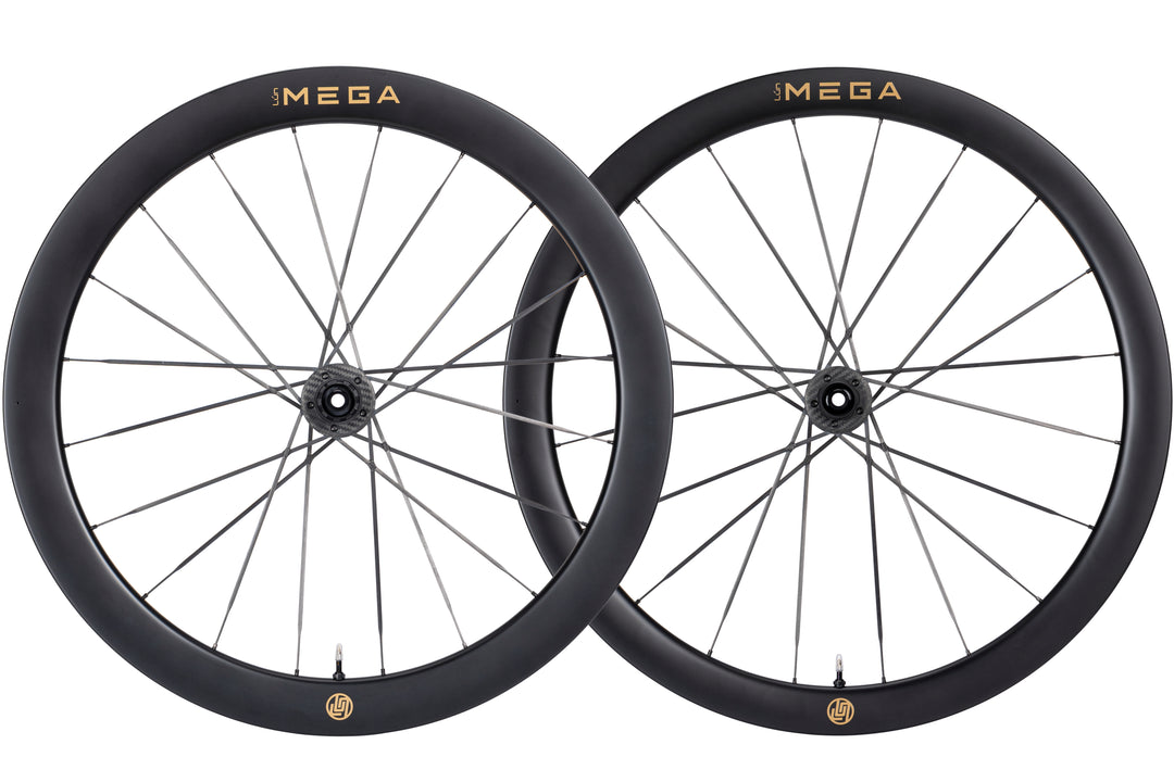 Lún MEGA D45 carbon disc wheelset with gold 'MEGA' branding, black rims, and Halo Spokes.