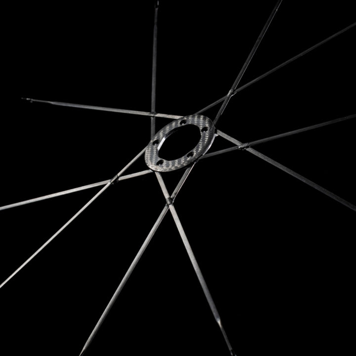 Lún MEGA D45 disc brake wheelset carbon hub with integrated Halo Spokes radiating outwards against black background.