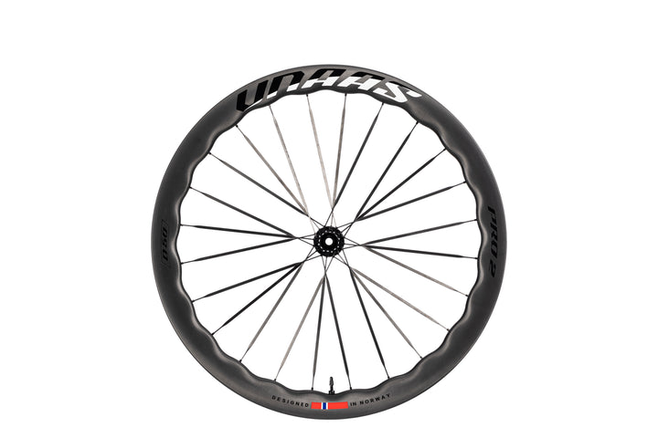 UNAAS Pro2 carbon fiber bicycle wheel featuring a unique wave rim and white branding, designed in Norway.