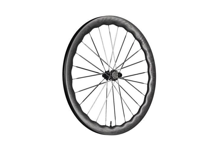 UNAAS Pro2 carbon bicycle wheel with distinctive wave rim, silver spokes, and black hub. Product appearance.
