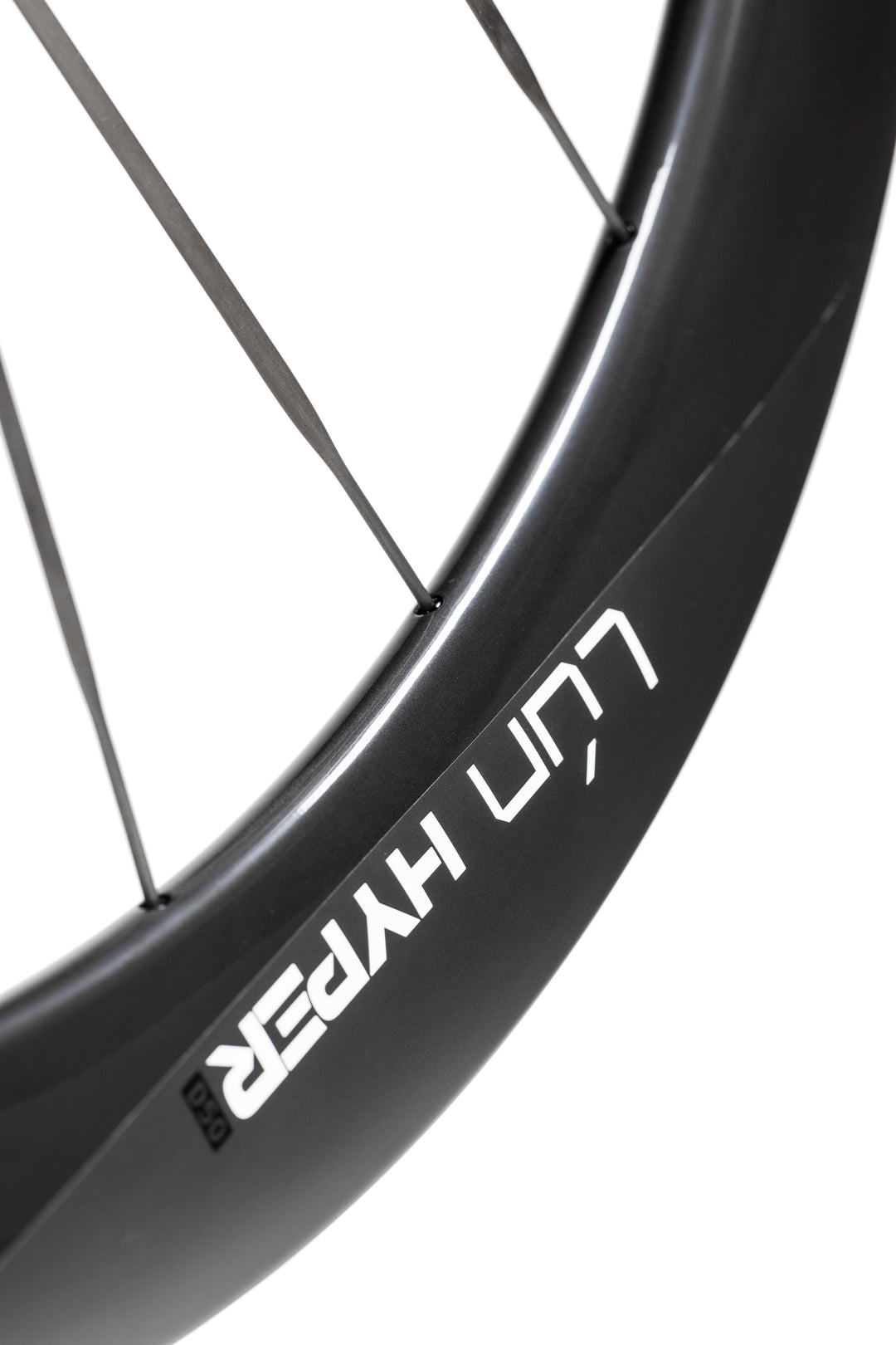 Matte black LUN HYPER 5 carbon fiber bicycle wheel with thin dark spokes and white branding on rim. Showcasing design.
