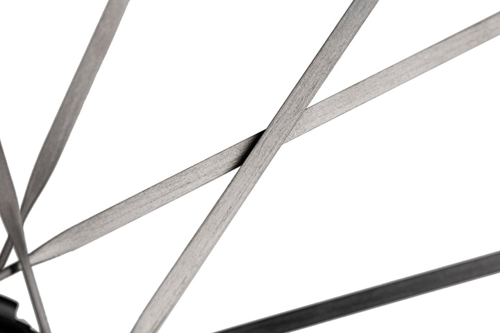 Close-up of HYPER 5 bicycle wheel with thin, flat, dark grey spokes against a white background.