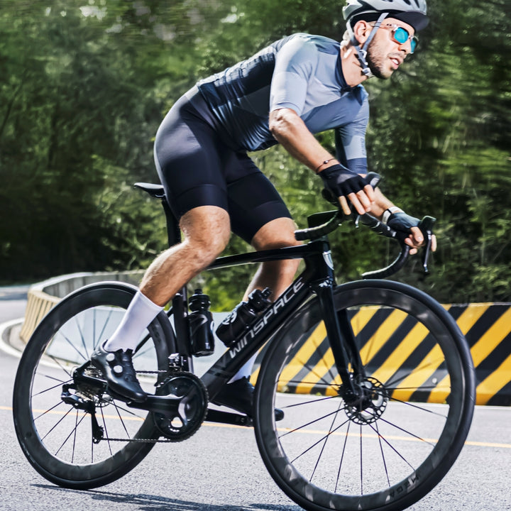 Black Winspace T1550 Gen 1 carbon road bike with white WINSPACE logo, disc brakes, and integrated cables, ridden by cyclist.