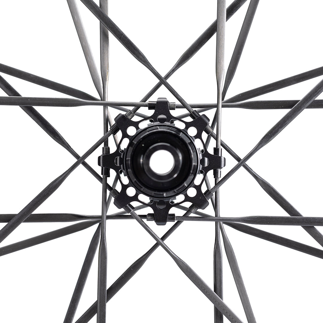 UNAAS Pro D40 wheelset hub with black ceramic bearings and carbon spokes close-up.